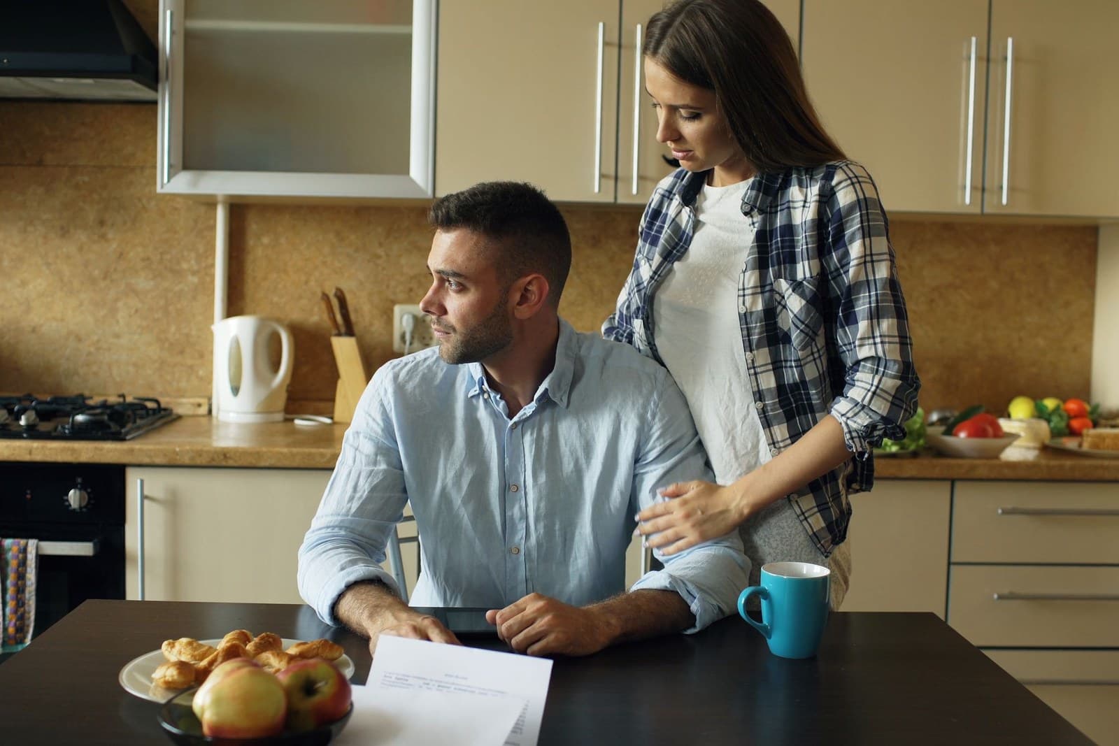 A couple at the kitchen table looking over documents
