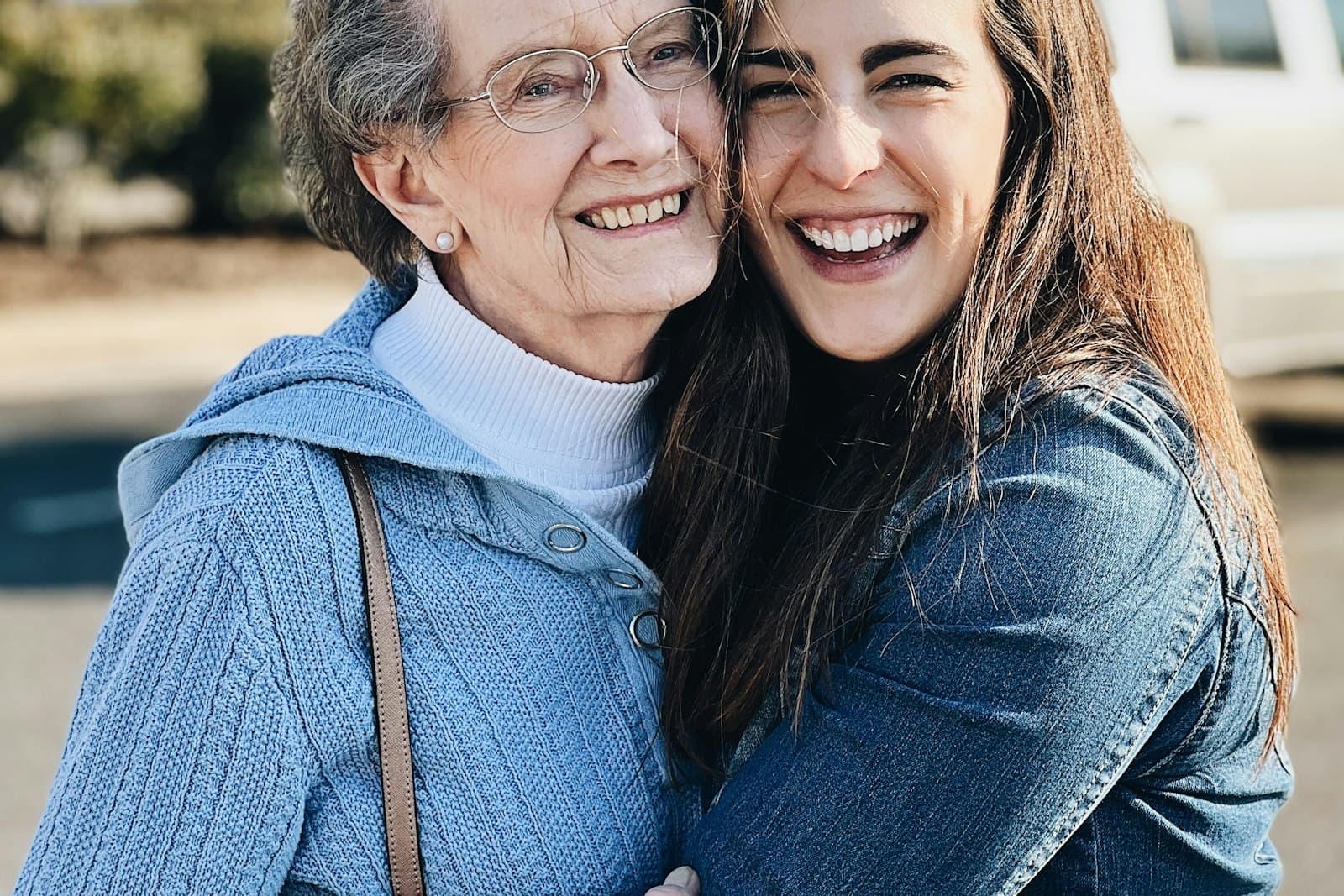 An older woman and a younger woman hugging and smiling